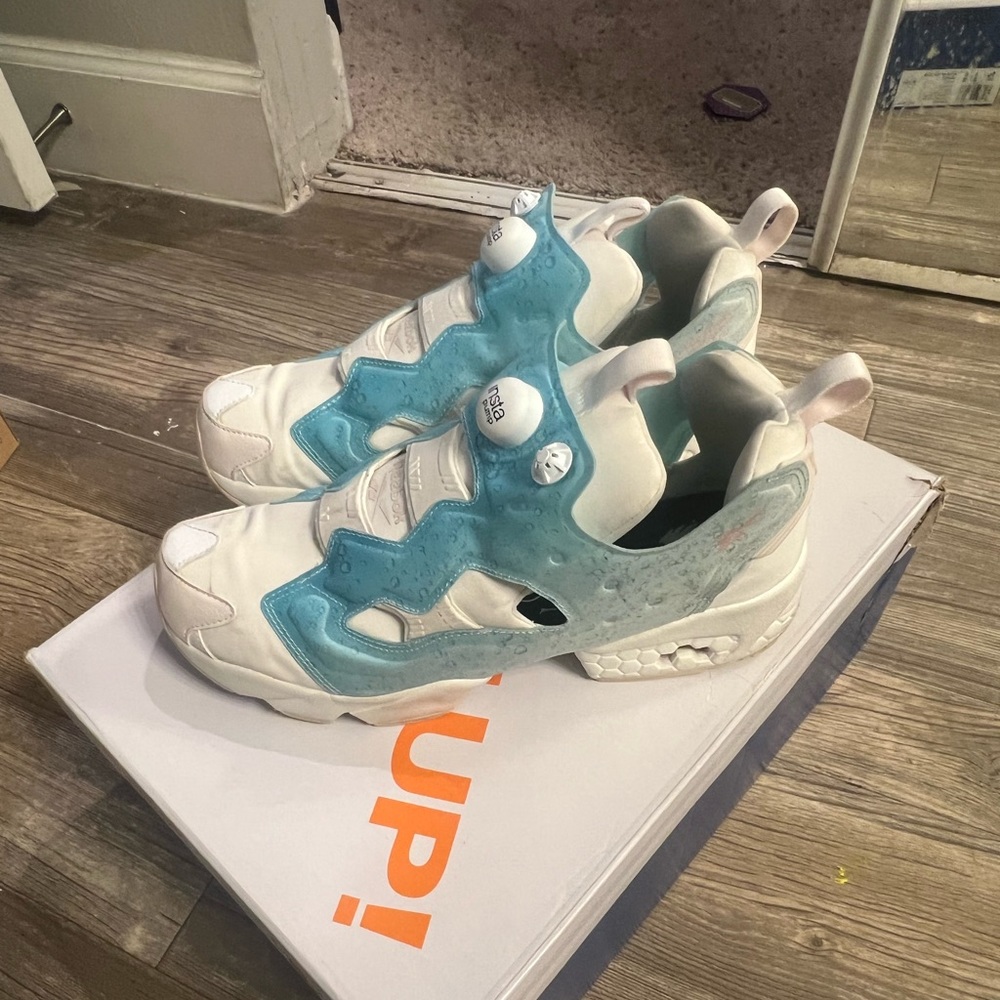 Light blue and white Reebok pumps. Size 10.